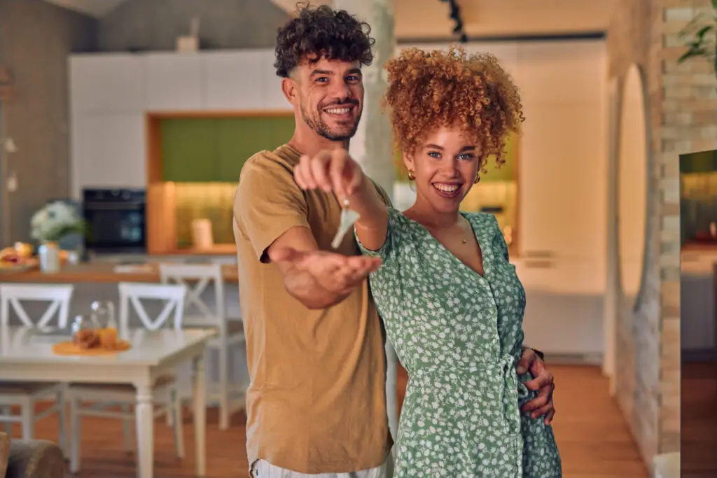 A Cheerful Young Couple Is Starting A New Life In The New Apartment