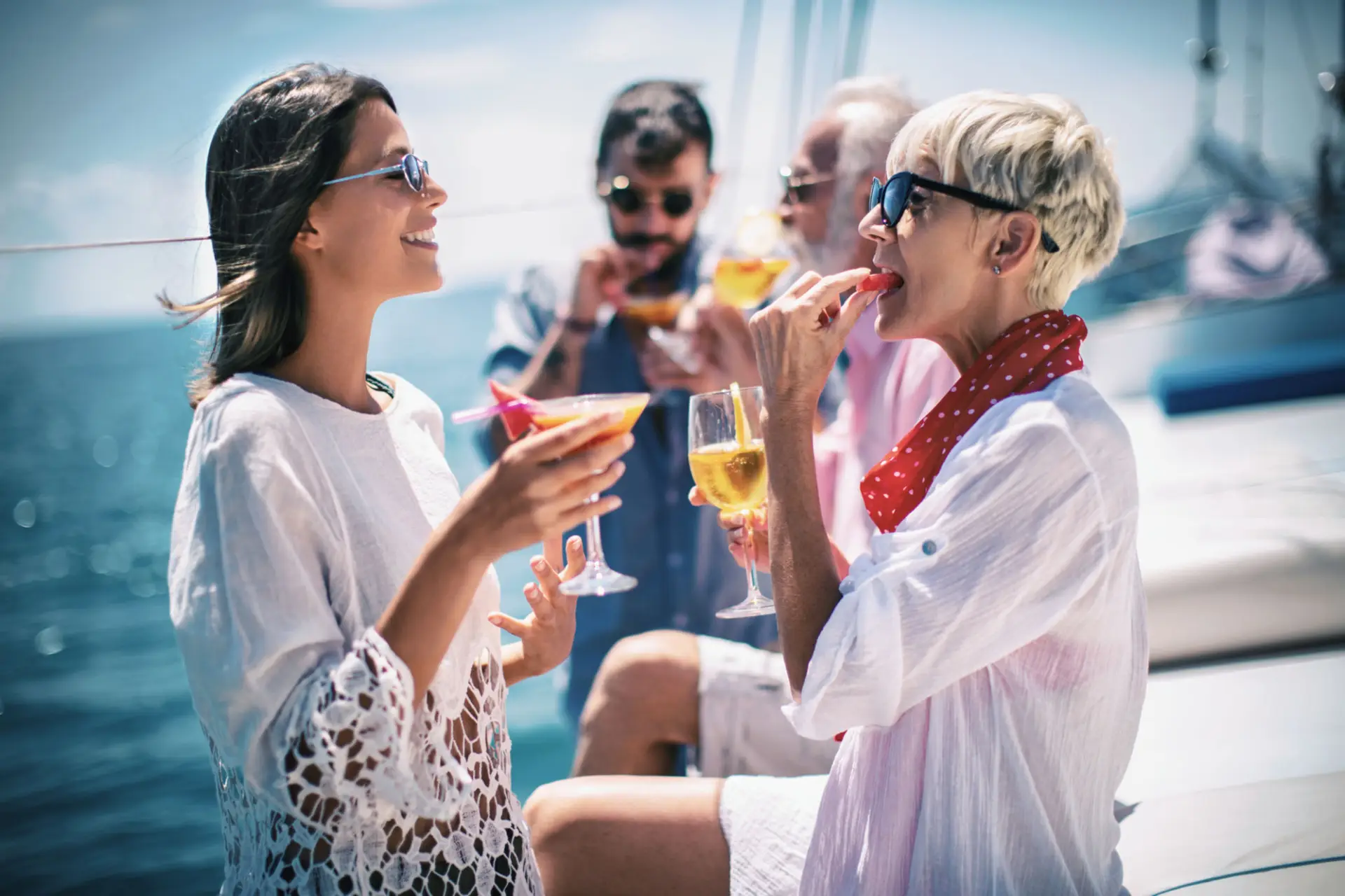 Family Drinking Cocktails On The Yacht And Enjoying A Beautiful Day Together