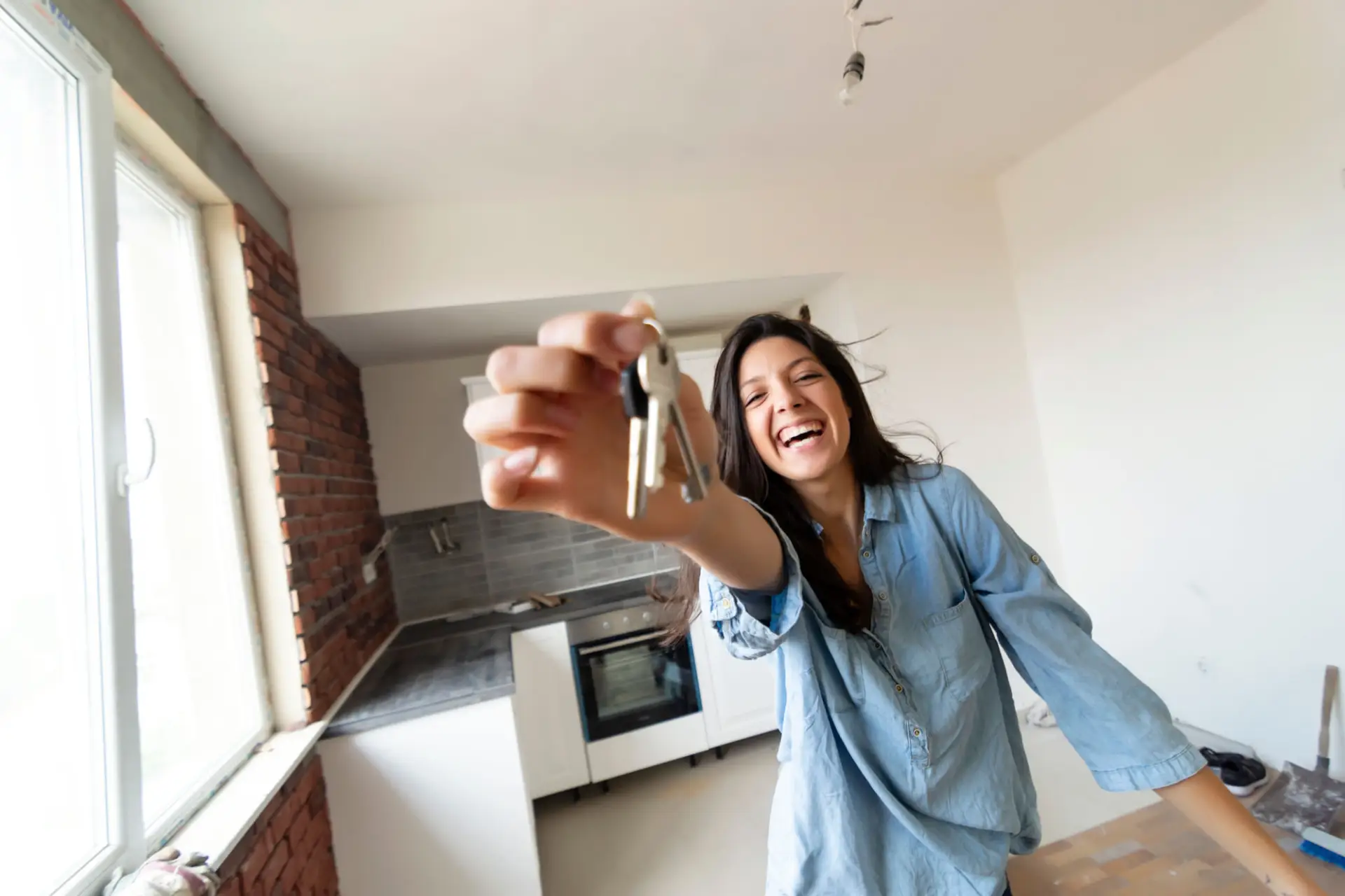 Happy Woman Holding Keys To Her New House